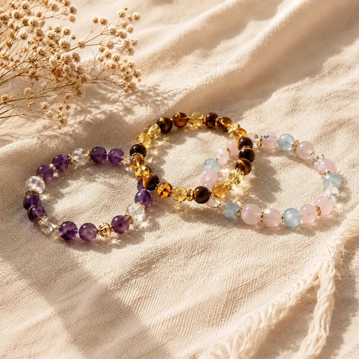 AURA Amulet best-selling crystal bracelet trio featuring amethyst, tiger eye, citrine,and rose quartz.