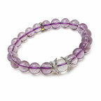 AURA Amulet Amethyst Bracelet with Clear Quartz, natural crystal beads and silver wings on white background, anxiety relief.

