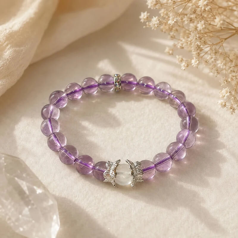 AURA Amulet amethyst crystal bracelet with angel wings, a stress relief gift for women displayed with crystals