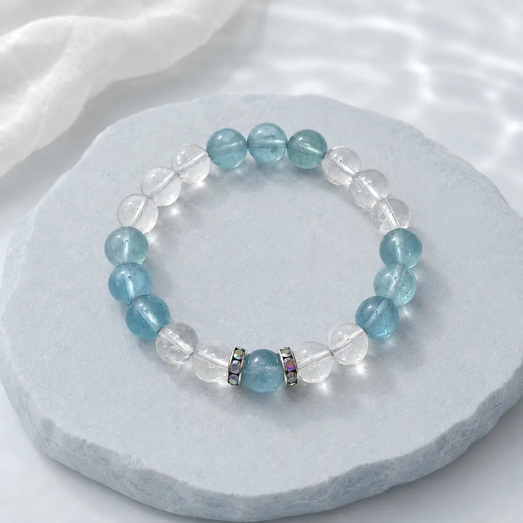 Aquamarine bracelet with clear quartz crystals styled in a soft calming scene