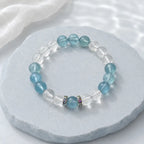 Aquamarine bracelet with clear quartz crystals styled in a soft calming scene