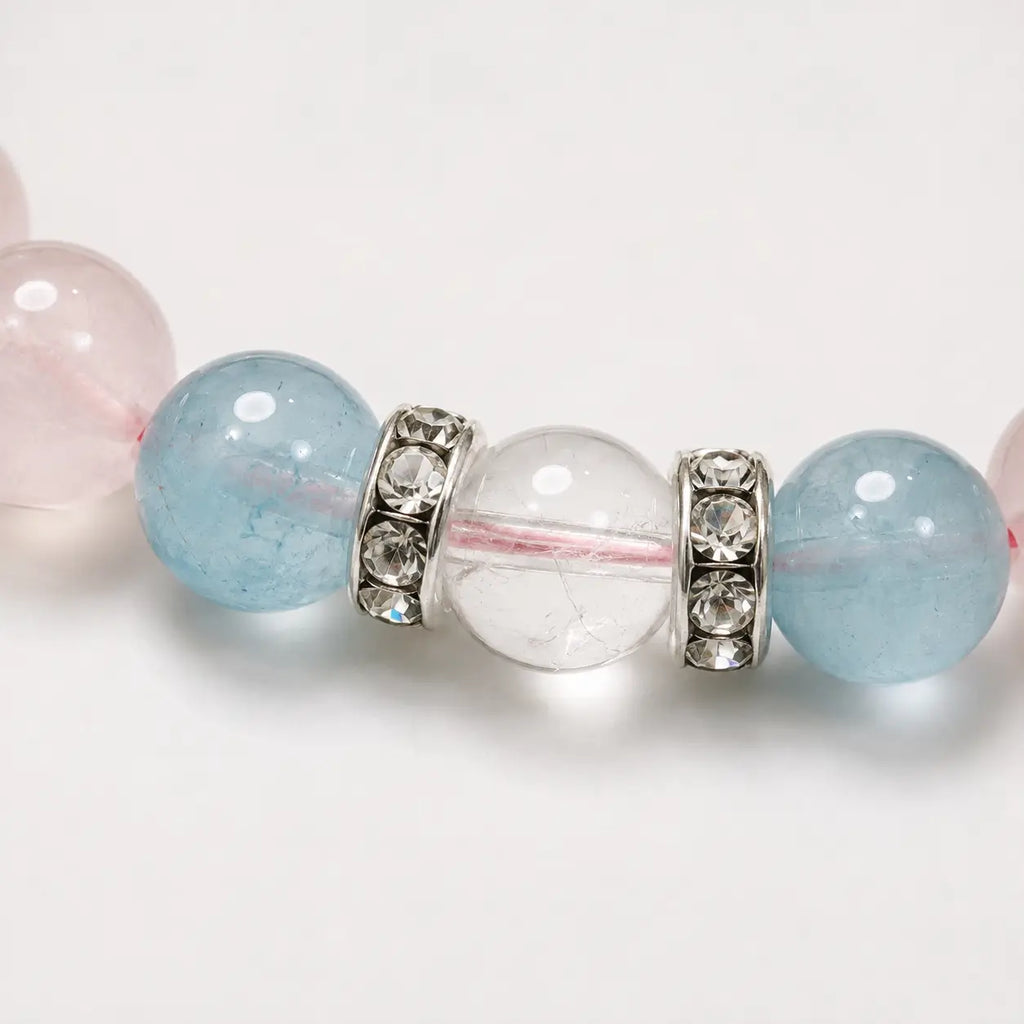 AURA Amulet macro shot of aquamarine natural stone with white crystal and sparkling silver bead spacers. 