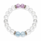 AURA Amulet clear quartz crystal bracelet featuring amethyst and aquamarine laid flat on clean white.