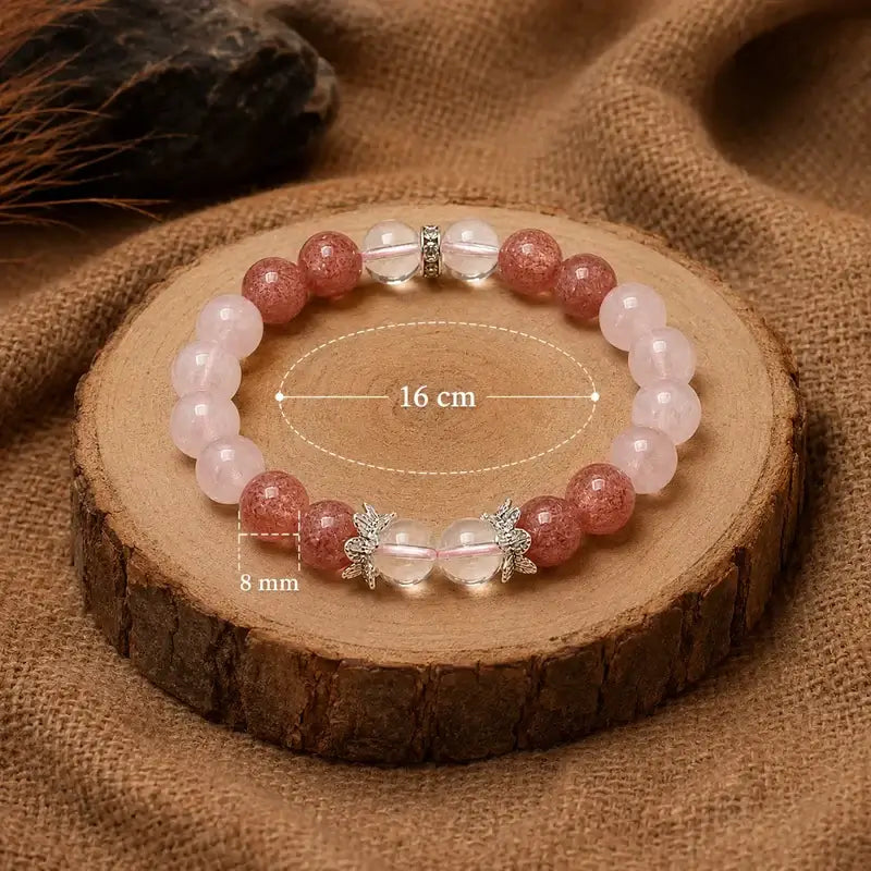 AURA Amulet Strawberry crystal bracelet size guide on wood slice, 8mm bead and 16cm inner loop. 