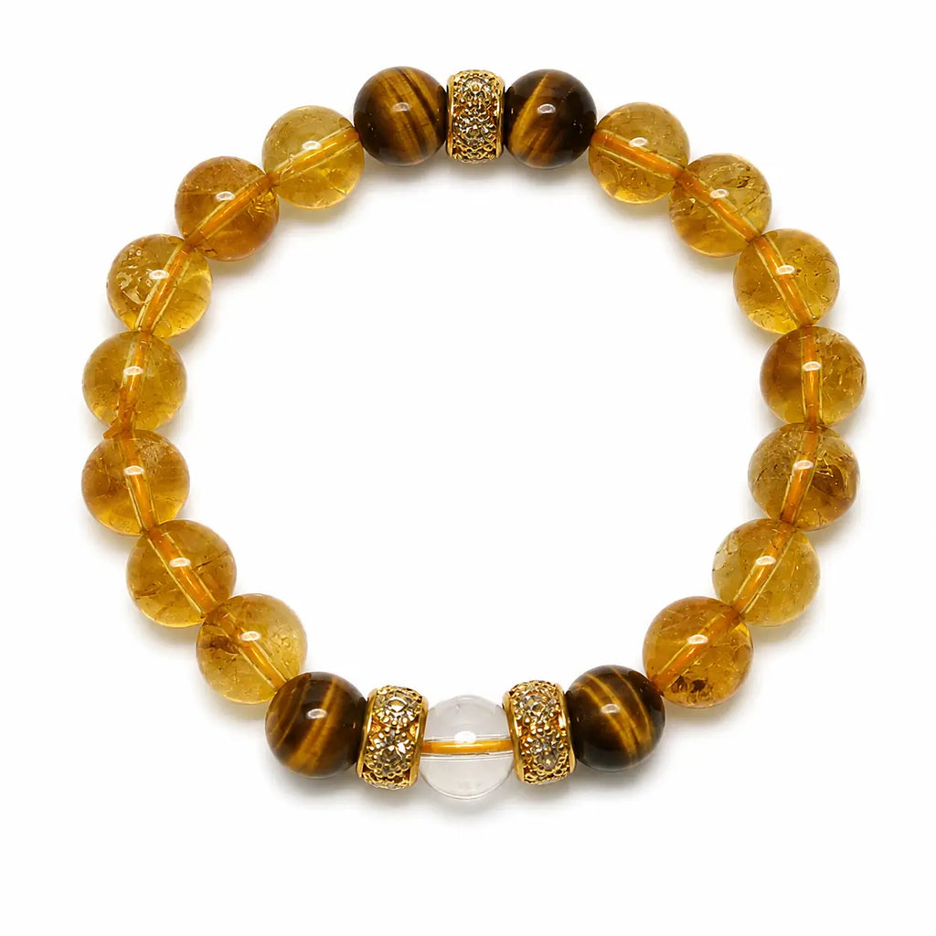 AURA Amulet citrine bracelet featuring tiger stone energy and clear quartz laid flat on white. 