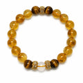 AURA Amulet citrine bracelet featuring tiger stone energy and clear quartz laid flat on white. 