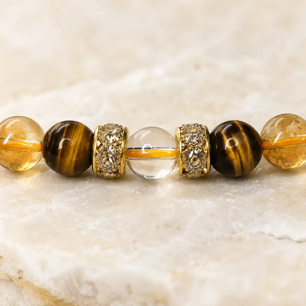 AURA Amulet macro shot of citrine bracelet with gold spacers and clear quartz, crystals for luck and success.