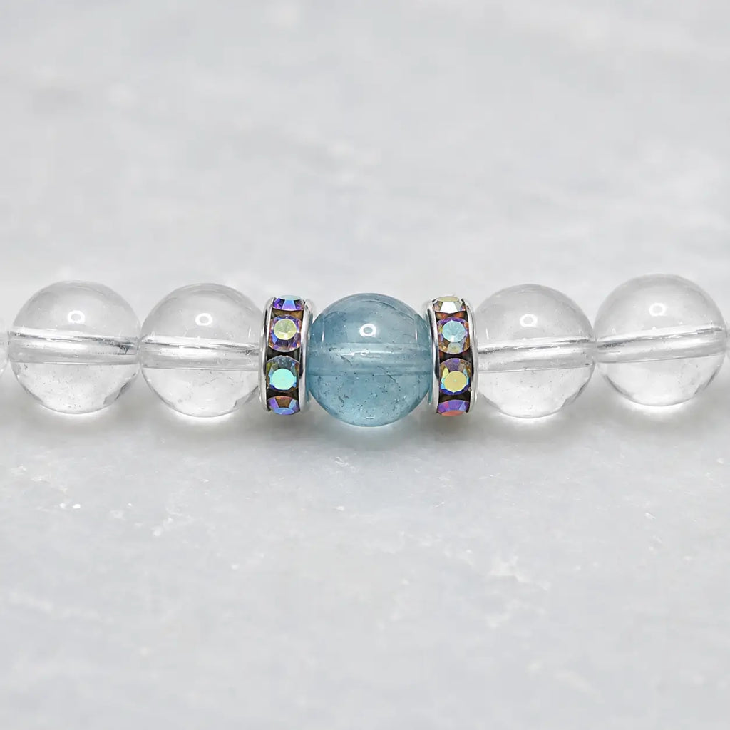 Close-up of aquamarine, clear quartz crystal beads and silver rhinestone spacers