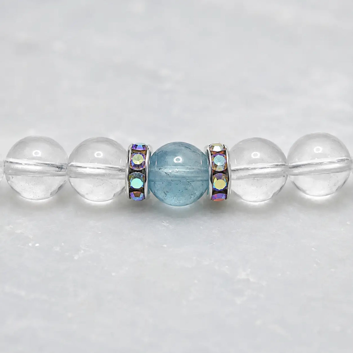 Close-up of aquamarine, clear quartz crystal beads and silver rhinestone spacers