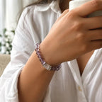 Woman wearing AURA Amulet amethyst crystal bracelet for anxiety relief while enjoying morning coffee.