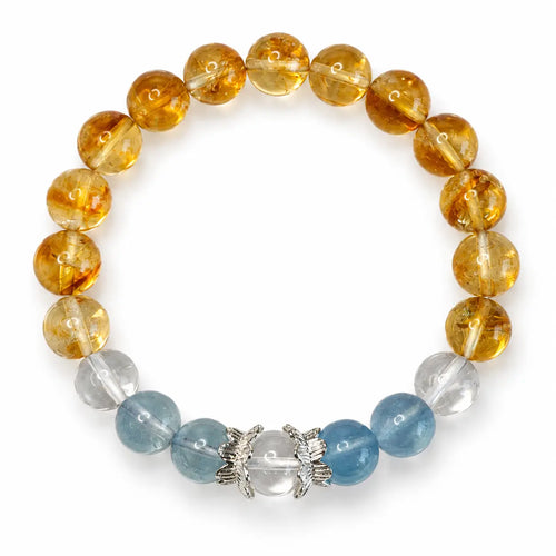 Overhead view of a round bracelet with golden citrine, blue aquamarine and clear quartz beads on white.