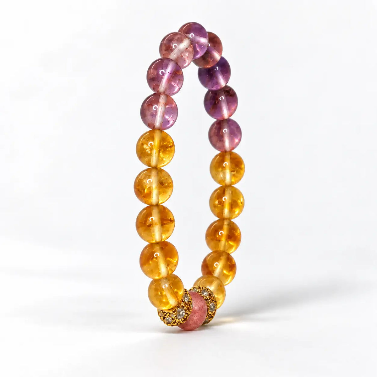 Upright citrine and amethyst bracelet showing round gemstone beads and gold-tone floral spacers.