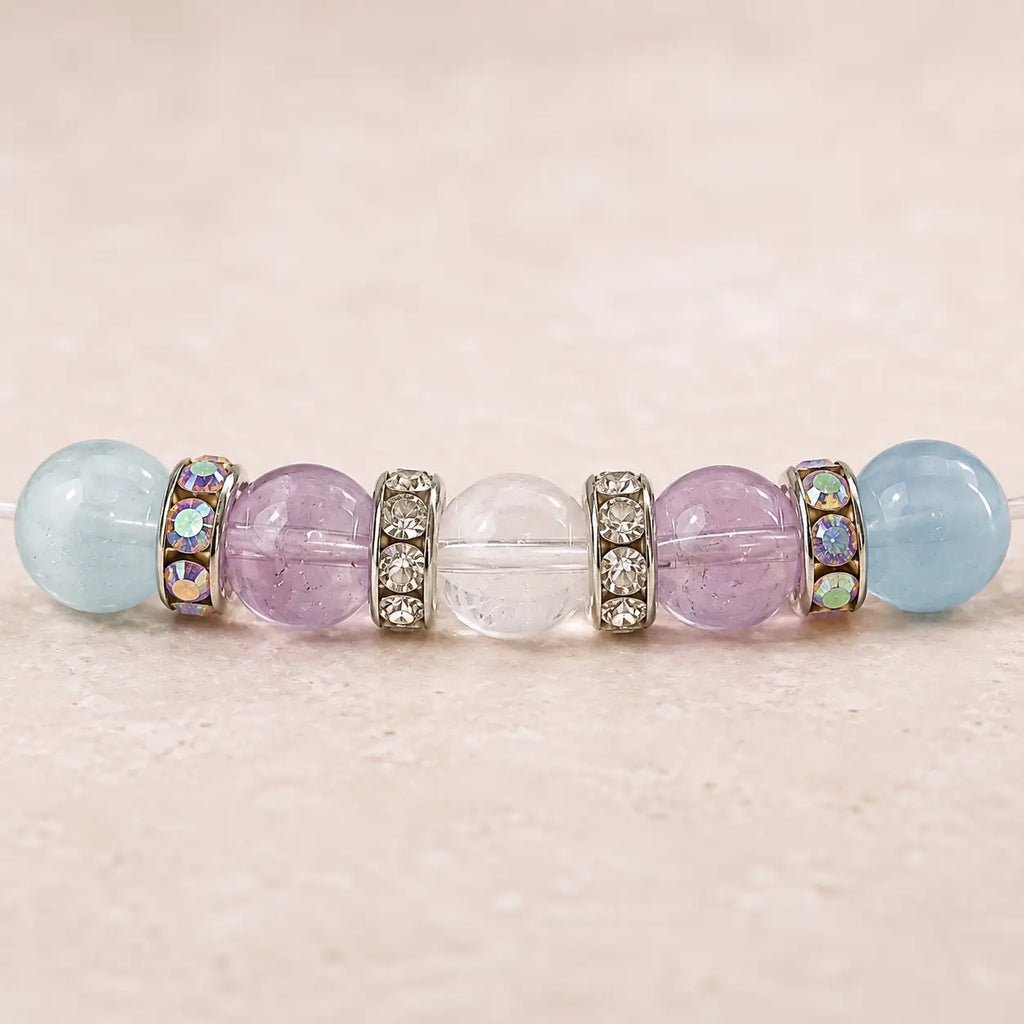 Close-up of aquamarine, amethyst and clear quartz beads with silver-tone rhinestone spacers