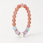 Upright strawberry quartz stretch bracelet showing the full circular bead arrangement