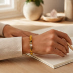 AURA Amulet lucky bracelet worn while journaling, bringing clarity and abundance to daily life. 