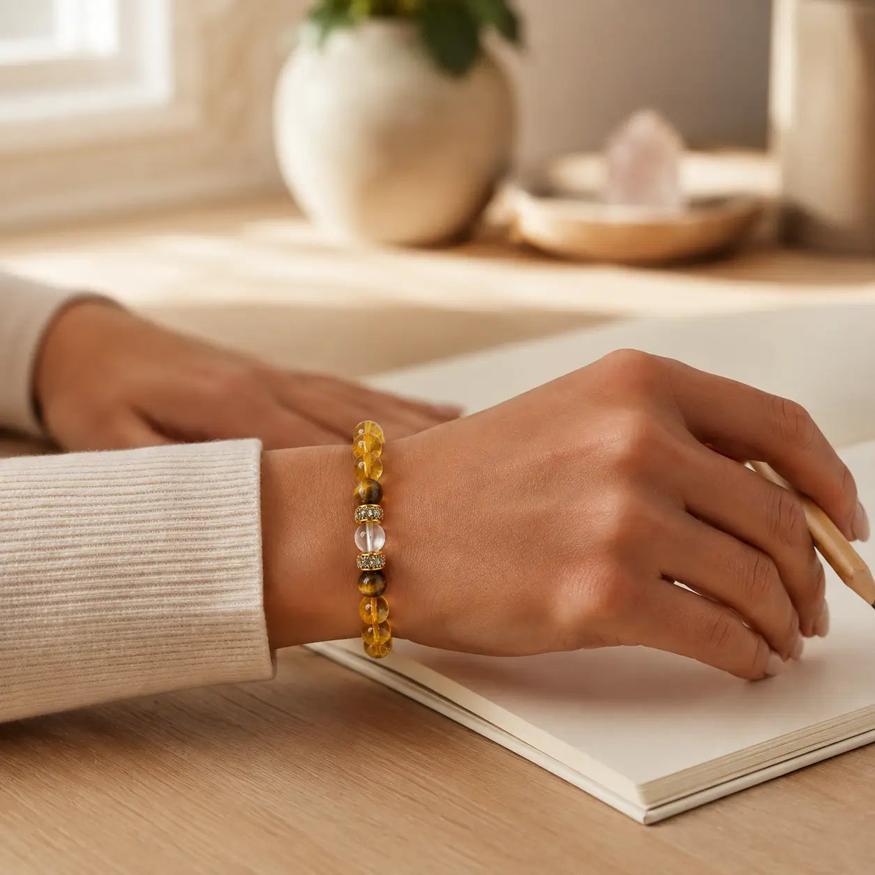 AURA Amulet lucky bracelet worn while journaling, bringing clarity and abundance to daily life. 