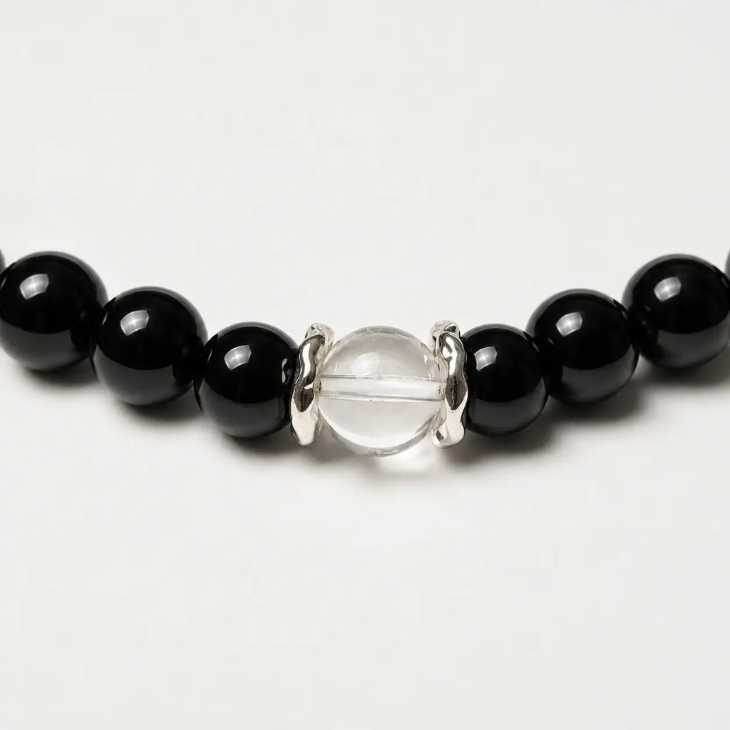 AURA Amulet macro detail of obsidian crystal bracelet with silver spacers and clear quartz, handmade jewelry.