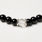 AURA Amulet macro detail of obsidian crystal bracelet with silver spacers and clear quartz, handmade jewelry.