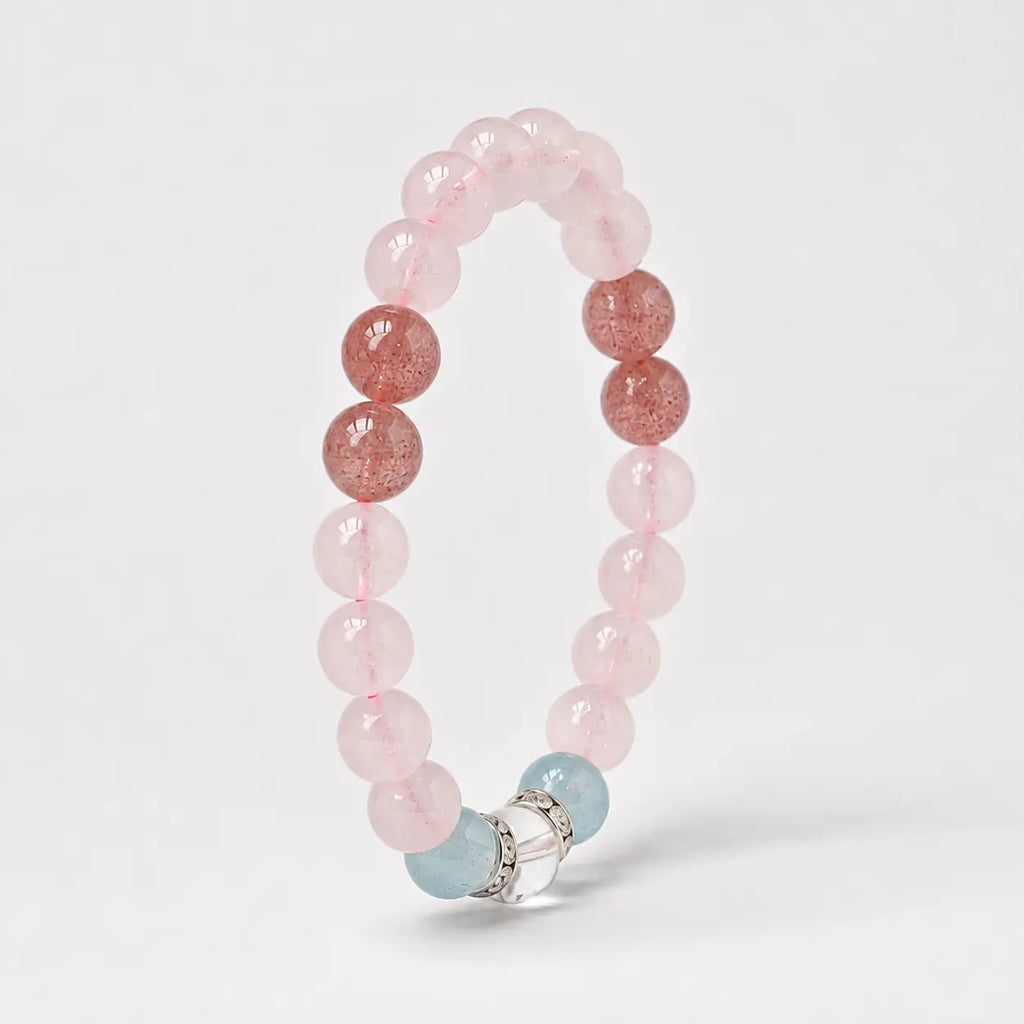 AURA Amulet angled rose quartz bracelet with strawberry crystal and silver rings, symbolizing self-love.