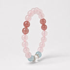 AURA Amulet angled rose quartz bracelet with strawberry crystal and silver rings, symbolizing self-love.