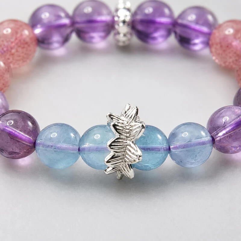 AURA Amulet silver charm macro detail with amethyst and aquamarine beads for energy healing.