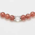 AURA Amulet macro detail of strawberry bracelet and clear quartz with silver accessories, a handmade charm bracelet.