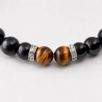 AURA Amulet macro closeup of tiger's eye and silver spacers on a women bracelet energy stone for protection. 